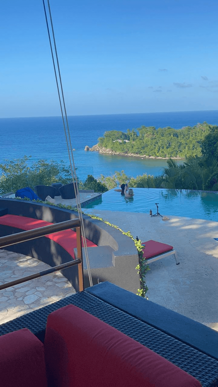 A poolside view looking across the sea.
